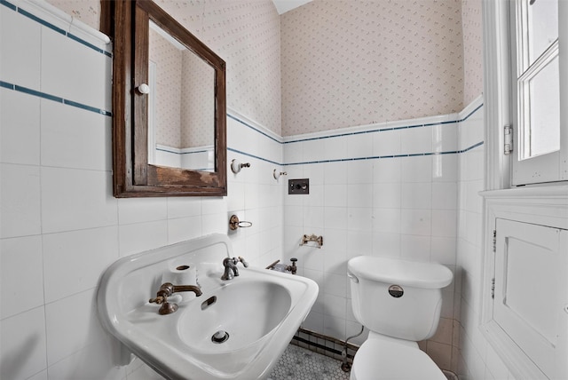 13 Garfield Pl, Poughkeepsie, NY 12601 - half bathroom with tile walls, wallpapered walls, and a wainscoted wall