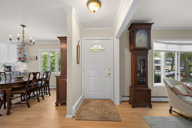54 Bankside Dr, Centerport, NY 11721 - foyer entrance with a baseboard radiator, light wood-style floors, a chandelier, and ornamental molding