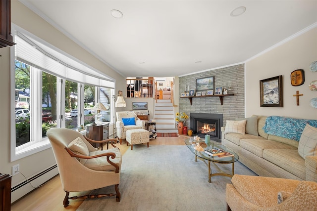 54 Bankside Dr, Centerport, NY 11721 - living room with baseboard heating, crown molding, wood finished floors, and a fireplace