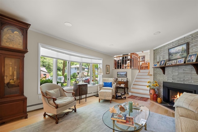 54 Bankside Dr, Centerport, NY 11721 - living room with baseboard heating, crown molding, a fireplace, light wood finished floors, and recessed lighting
