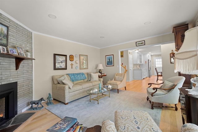 54 Bankside Dr, Centerport, NY 11721 - living room featuring light wood-style floors, crown molding, and a brick fireplace