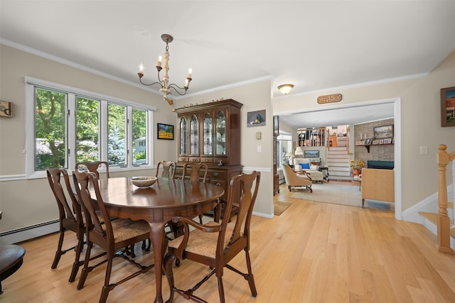54 Bankside Dr, Centerport, NY 11721 - dining room featuring a brick fireplace, a chandelier, light wood-type flooring, baseboard heating, and ornamental molding