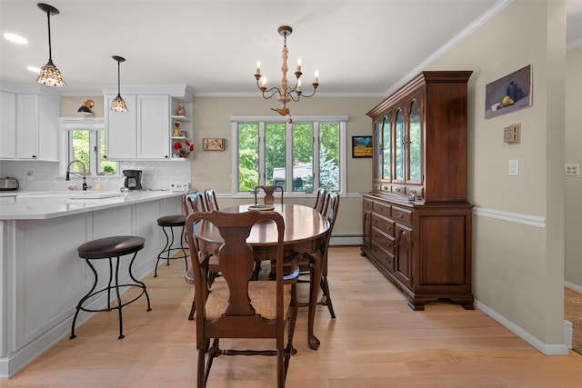 54 Bankside Dr, Centerport, NY 11721 - dining room featuring baseboard heating, a chandelier, light wood-style flooring, and crown molding