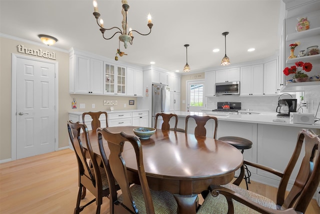 54 Bankside Dr, Centerport, NY 11721 - dining space featuring light wood-style floors, crown molding, a chandelier, and recessed lighting