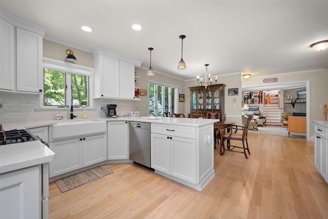 54 Bankside Dr, Centerport, NY 11721 - kitchen featuring stainless steel dishwasher, a peninsula, crown molding, light wood-type flooring, and decorative backsplash