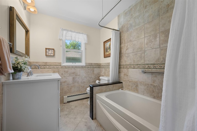 54 Bankside Dr, Centerport, NY 11721 - bathroom with a baseboard radiator, tile walls, vanity, tile patterned floors, and a wainscoted wall