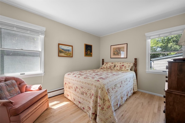 54 Bankside Dr, Centerport, NY 11721 - bedroom featuring a baseboard heating unit and light wood-style flooring
