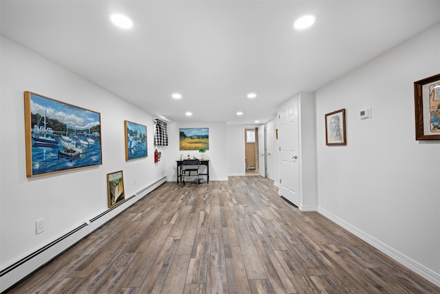 54 Bankside Dr, Centerport, NY 11721 - unfurnished living room with a baseboard heating unit, recessed lighting, and wood finished floors