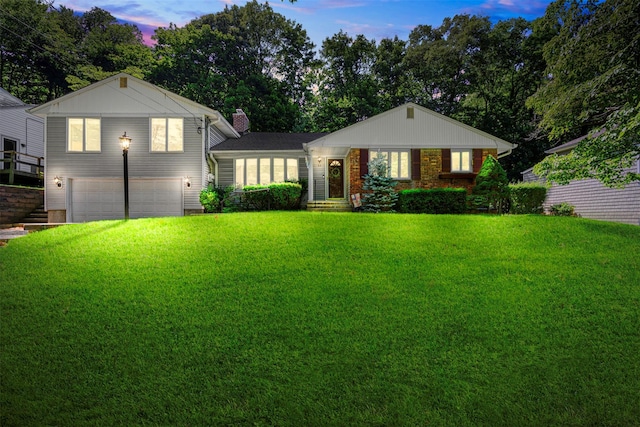 54 Bankside Dr, Centerport, NY 11721 - view of front of house with an attached garage, a yard, and a chimney