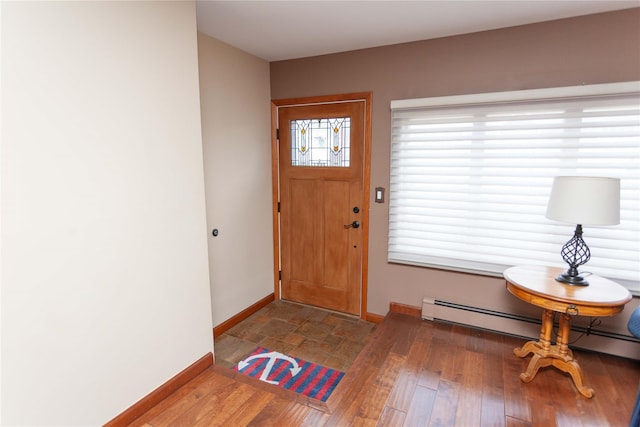 66 Parma Rd, Island Park, NY 11558 - entrance foyer featuring baseboard heating and stone finish floors