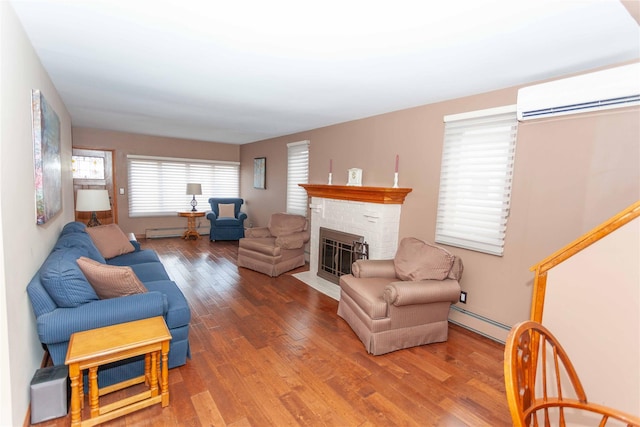 66 Parma Rd, Island Park, NY 11558 - living area with a baseboard heating unit, a fireplace, wood finished floors, a wall mounted air conditioner, and baseboard heating