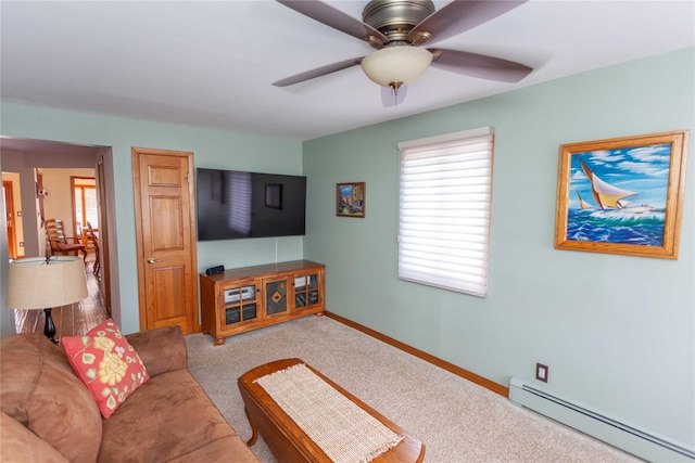 66 Parma Rd, Island Park, NY 11558 - carpeted living area featuring a baseboard heating unit, healthy amount of natural light, and a ceiling fan