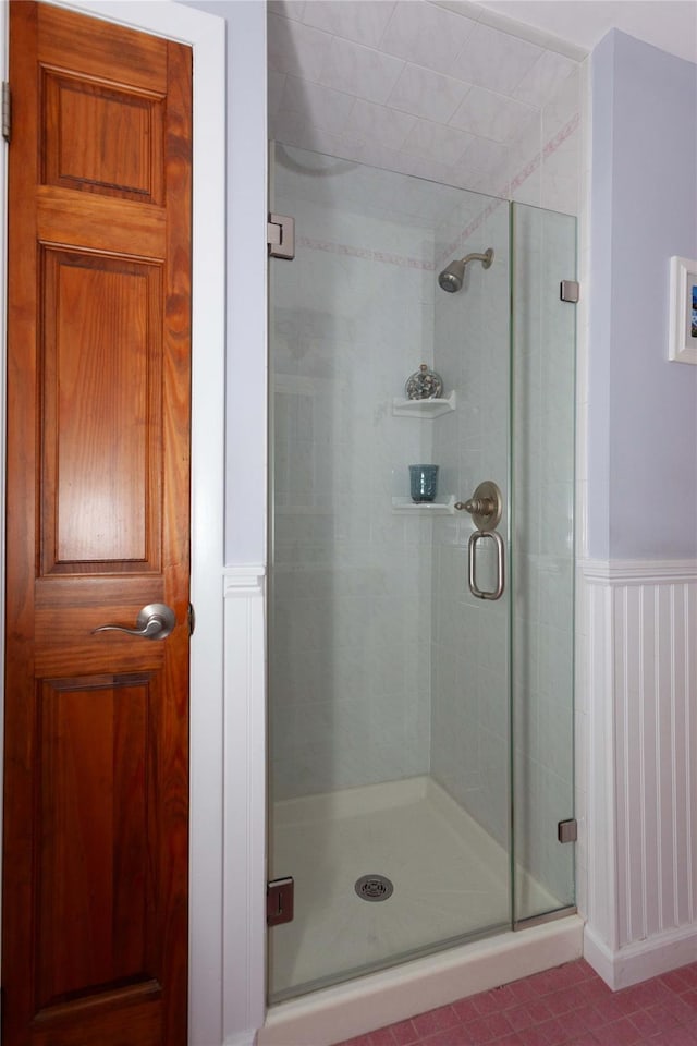66 Parma Rd, Island Park, NY 11558 - full bathroom with a stall shower, a wainscoted wall, tile patterned floors, and a decorative wall