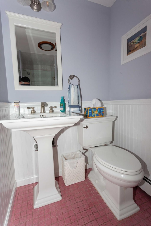 66 Parma Rd, Island Park, NY 11558 - bathroom with a wainscoted wall, tile patterned flooring, and a baseboard heating unit