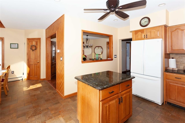 66 Parma Rd, Island Park, NY 11558 - kitchen with freestanding refrigerator, stone tile floors, a baseboard radiator, a ceiling fan, and tasteful backsplash