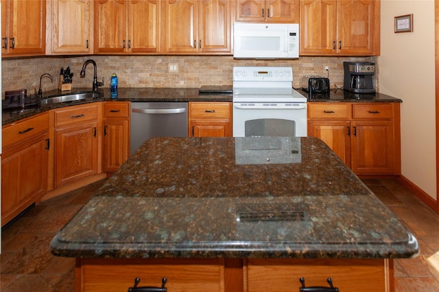 66 Parma Rd, Island Park, NY 11558 - kitchen featuring white appliances, backsplash, dark stone counters, brown cabinetry, and a center island