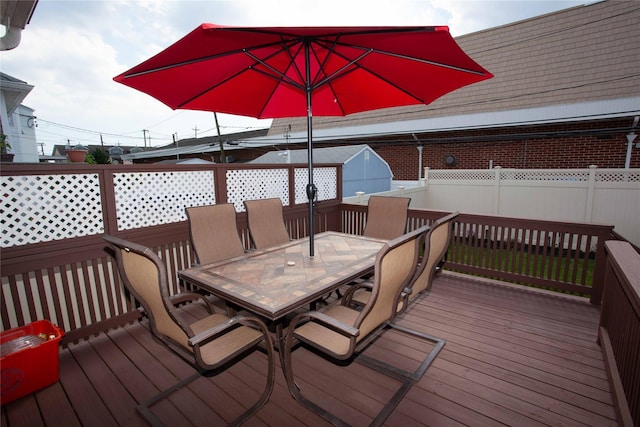 66 Parma Rd, Island Park, NY 11558 - deck featuring outdoor dining space, a fenced backyard, and a shed
