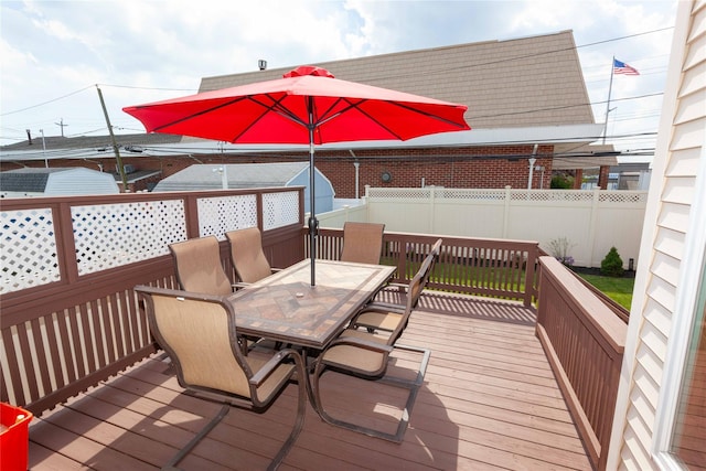 66 Parma Rd, Island Park, NY 11558 - wooden deck with outdoor dining space and a fenced backyard