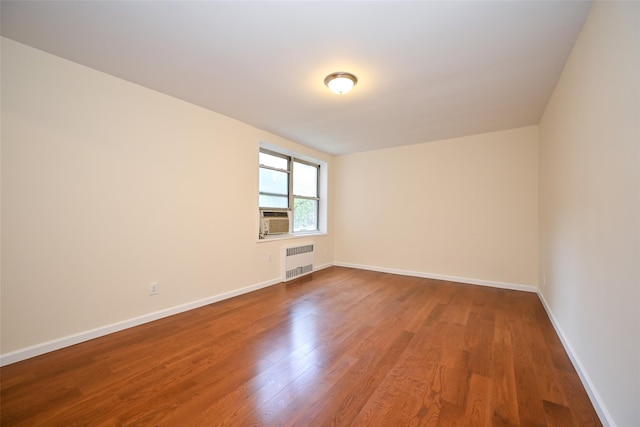 26-21 Union St Unit 1B, Flushing, NY 11354 - unfurnished room with wood finished floors, radiator, and cooling unit