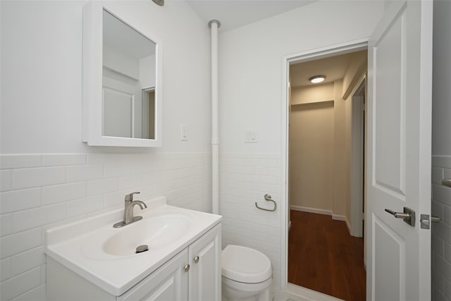 26-21 Union St Unit 1B, Flushing, NY 11354 - bathroom with vanity, tile walls, wood finished floors, and a wainscoted wall
