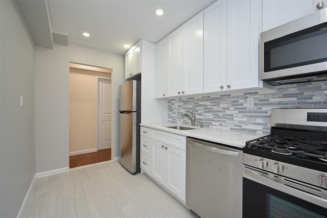 26-21 Union St Unit 1B, Flushing, NY 11354 - kitchen with appliances with stainless steel finishes, backsplash, white cabinets, and recessed lighting
