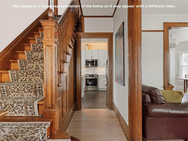 135 Washington Ave, Saugerties, NY 12477 - corridor with light wood-style floors, stairway, and crown molding