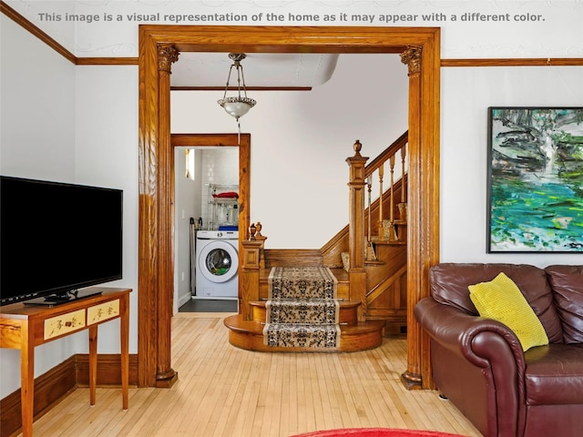 135 Washington Ave, Saugerties, NY 12477 - living room with washer / clothes dryer, stairway, ornamental molding, and hardwood / wood-style flooring