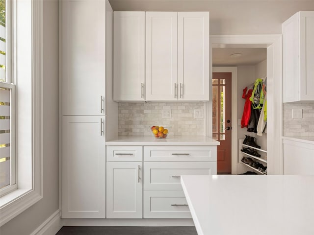 135 Washington Ave, Saugerties, NY 12477 - kitchen with decorative backsplash, light countertops, and white cabinets