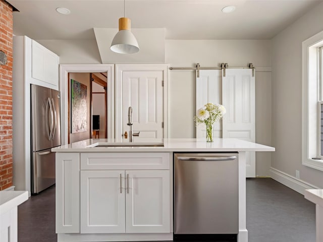 135 Washington Ave, Saugerties, NY 12477 - kitchen with stainless steel appliances, brick wall, white cabinets, light countertops, and a kitchen island with sink