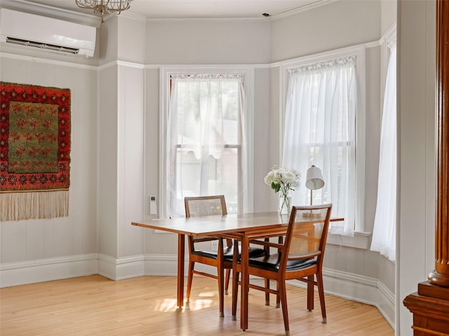 135 Washington Ave, Saugerties, NY 12477 - dining area with an AC wall unit, light wood finished floors, ornamental molding, and a chandelier