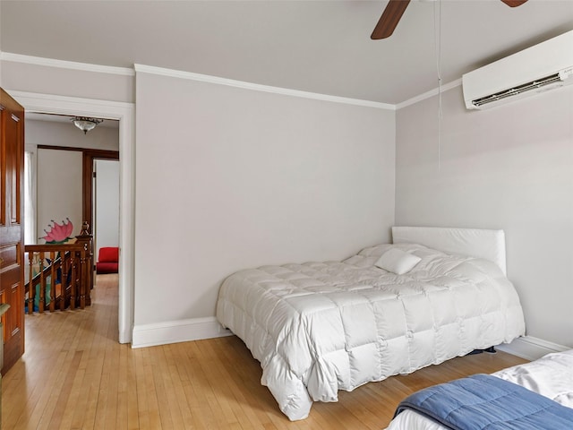 135 Washington Ave, Saugerties, NY 12477 - bedroom with a wall mounted air conditioner, crown molding, light wood-style floors, and ceiling fan