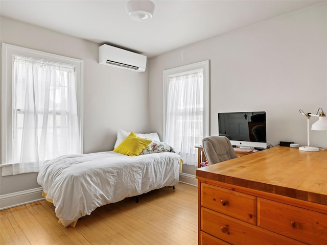 135 Washington Ave, Saugerties, NY 12477 - bedroom with a wall mounted air conditioner, an office area, and light wood finished floors