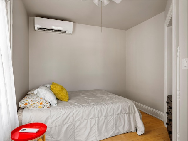 135 Washington Ave, Saugerties, NY 12477 - bedroom featuring an AC wall unit and wood finished floors