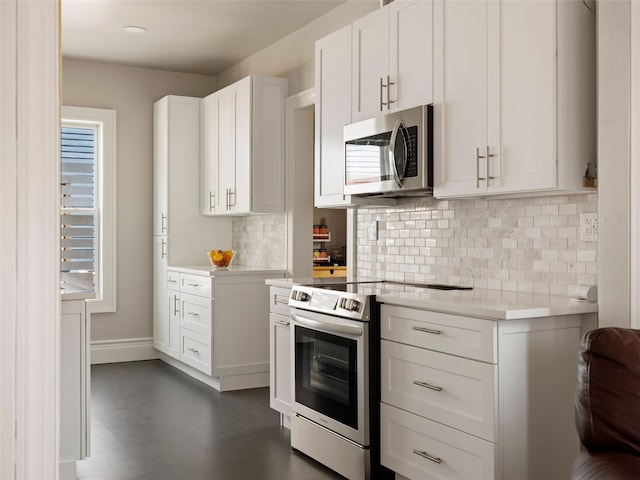 135 Washington Ave, Saugerties, NY 12477 - kitchen with stainless steel appliances, decorative backsplash, light countertops, and white cabinetry
