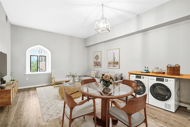 55 Mckinley Ave Unit D3-14, White Plains, NY 10606 - dining space featuring washer and clothes dryer, light wood-style floors, and a baseboard radiator