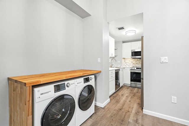 55 Mckinley Ave Unit D3-14, White Plains, NY 10606 - laundry area featuring washing machine and clothes dryer and light wood-type flooring