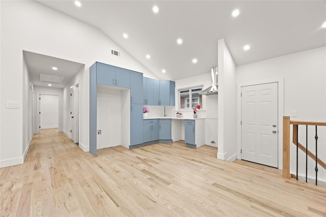 226-07 76th Rd, Bayside, NY 11364 - kitchen with blue cabinets, wall chimney range hood, light wood-style floors, recessed lighting, and light countertops