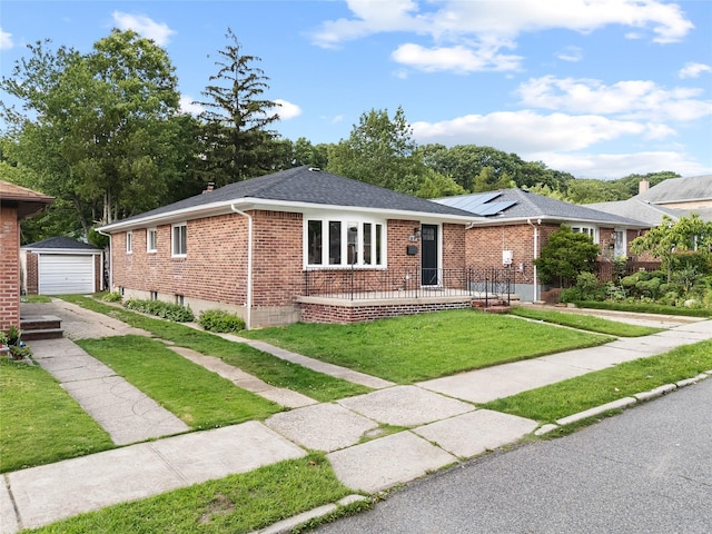 226-07 76th Rd, Bayside, NY 11364 - single story home with concrete driveway, brick siding, a garage, a front lawn, and an outbuilding