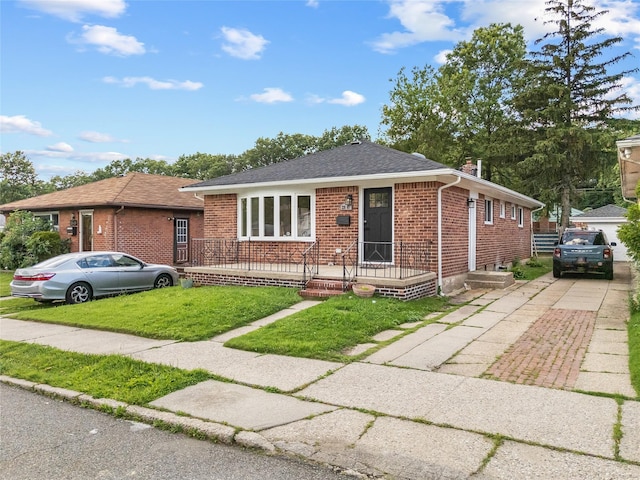 226-07 76th Rd, Bayside, NY 11364 - view of front of property with brick siding, a chimney, a front yard, and roof with shingles