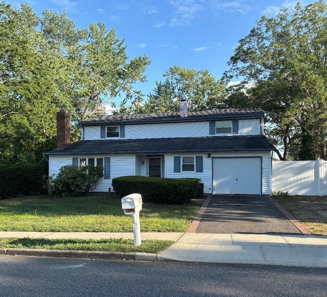 12 Executive Rd, Selden, NY 11784 - traditional-style house with driveway, a chimney, and a garage