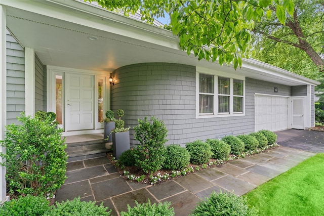 63 Sutton Pl, Manhasset, NY 11030 - property entrance featuring asphalt driveway and an attached garage