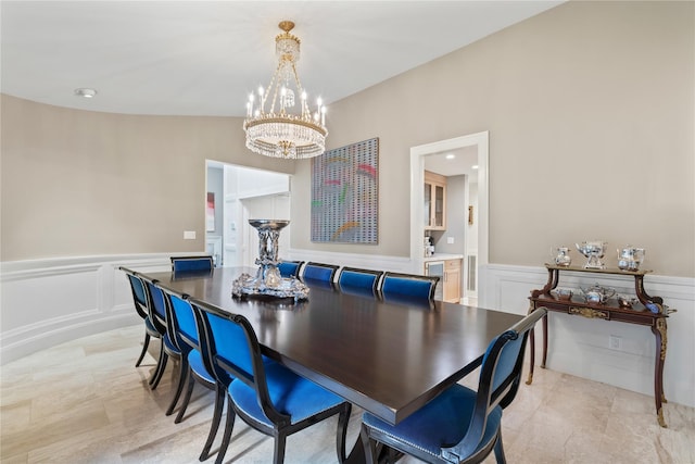 63 Sutton Pl, Manhasset, NY 11030 - dining space with a chandelier, a wainscoted wall, and a decorative wall