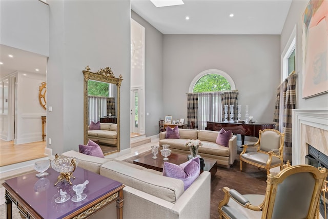 63 Sutton Pl, Manhasset, NY 11030 - living area featuring a high ceiling, a fireplace, recessed lighting, and a skylight