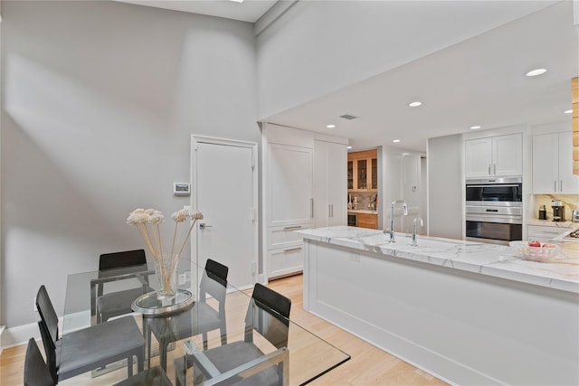 63 Sutton Pl, Manhasset, NY 11030 - dining area with light wood finished floors, recessed lighting, and a high ceiling