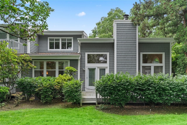 63 Sutton Pl, Manhasset, NY 11030 - rear view of property with a chimney, a wooden deck, and a yard