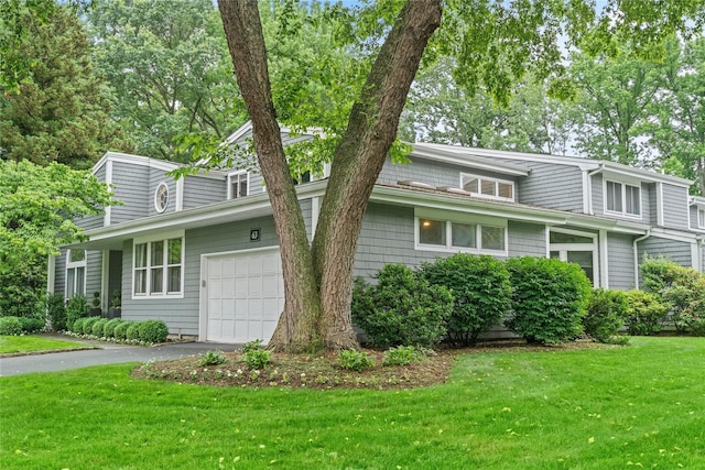 63 Sutton Pl, Manhasset, NY 11030 - view of front of home with an attached garage, a front yard, and driveway