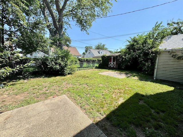 23 Chase Ln, Levittown, NY 11756 - view of yard featuring a storage unit and a patio