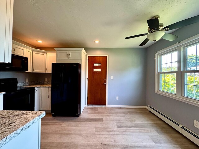 23 Chase Ln, Levittown, NY 11756 - kitchen featuring black appliances, a baseboard radiator, light wood finished floors, white cabinetry, and ceiling fan