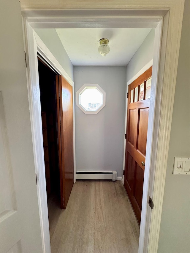 23 Chase Ln, Levittown, NY 11756 - doorway with baseboard heating and light wood-type flooring