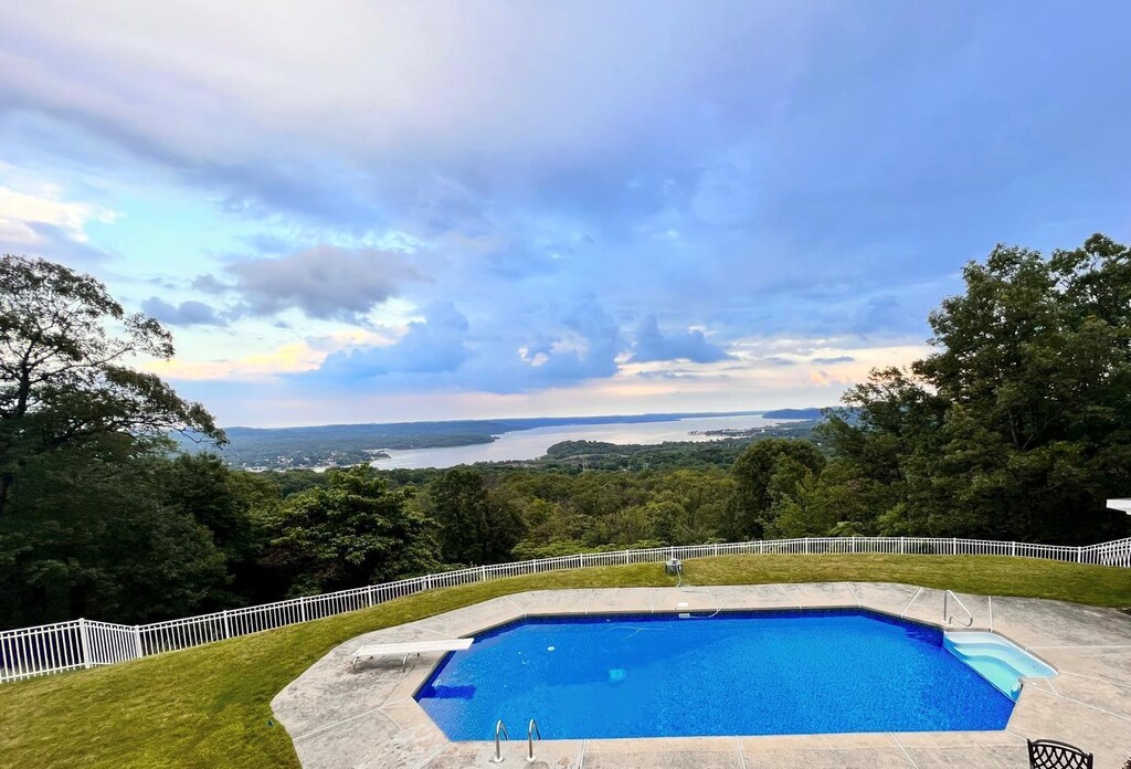 10 Soluri Ln, Tomkins Cove, NY 10986 - view of swimming pool featuring a fenced backyard, a wooded view, a patio area, and a diving board